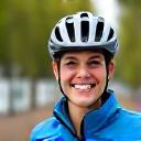 Portrait of a smiling woman in cycling gear.